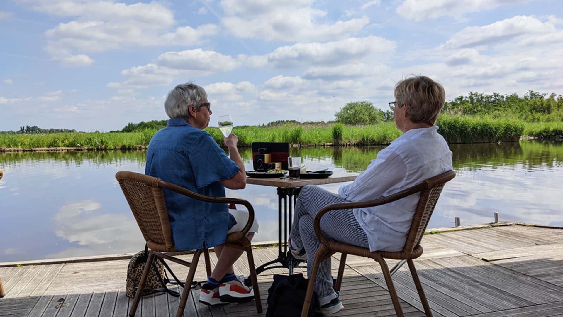twee dames lunchen op het terras van 't Jachthuis aan het water van de Foppenplas in Midden-Delfland zomer zonnige dames