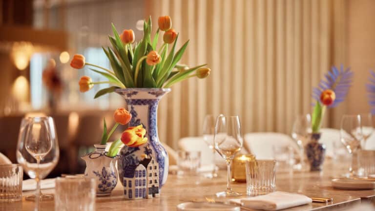 gedenkte tafel met bestek glazen en tulpen in delfts blauwe vazen bij het Van der Valk Hotel Delft A4